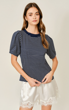 Load image into Gallery viewer, Woman wearing a navy and white striped shirt with white shorts.
