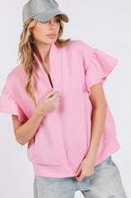 Load image into Gallery viewer, Woman wearing a pink ruffled sleeve blouse and denim cap on a white background
